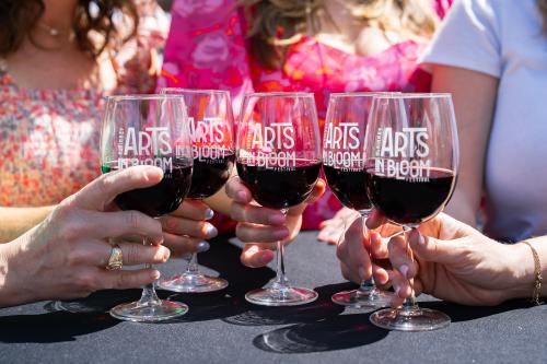 Close up photo of wine glasses at Arts In Bloom Wine Garden
