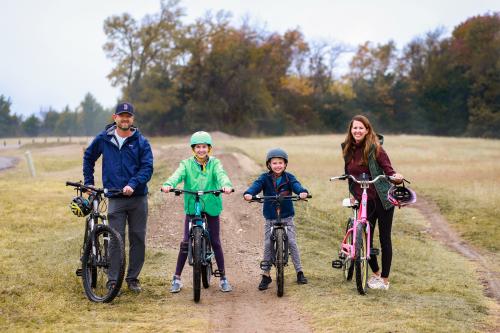 Family of four on bicycles in a field