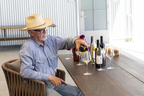 Lee Hudson, co-owner of Hudson Ranch, pours wines in Napa Valley, CA