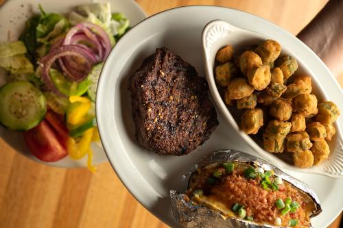 The steak, fried okra, and loaded baked potato make for a hearty meal at Pioneer Steak House.