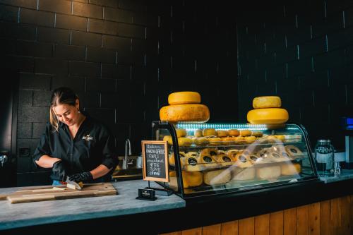 Woman cutting cheese at New Galma