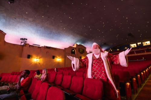 Santa standing by the seat at the Plaza Theatre in Palm Springs