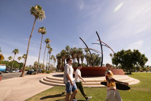 Three guys walking in front of the Fountain at Frances Stevens Park in Palm Springs.