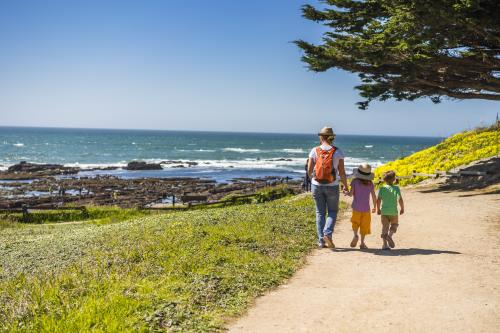 Family walking the trail at Fitzgerald Marine Reserve in San Mateo County.