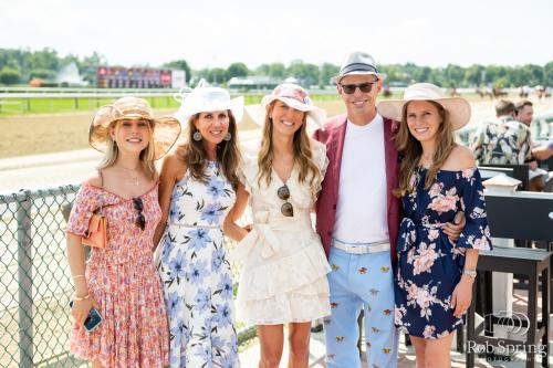 people smiling for photo at race course
