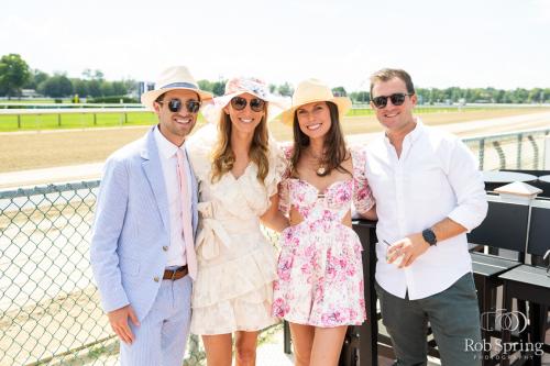 two couples dressed in race course attire