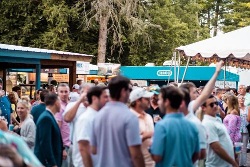 people in patio with tents and outdoor bars