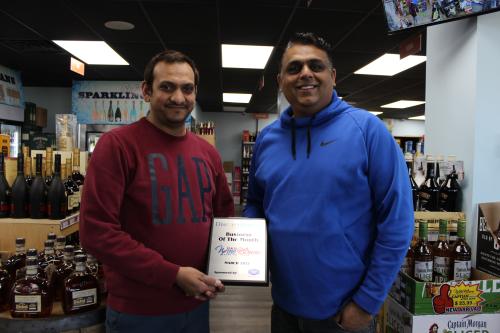 Staff from 5&20 Wine & Spirits posing with the March 2021 Business of the Month Plaque