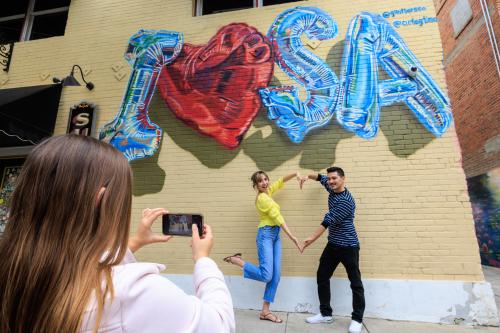 Couple in front of I HEART mural