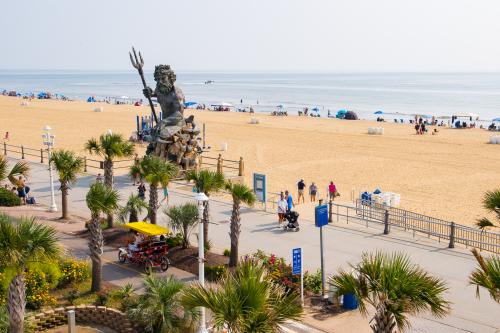 King Neptune statue on a boardwalk with the beach in the background