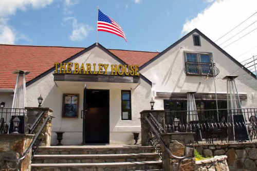 An outside photo of The Barley House restaurant with patio seating.