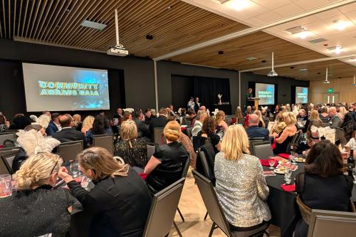 Wide shot of Woodbury Chamber of Commerce 2026 Gala at Central Park with speaker at stage with hundreds of people in attendance.