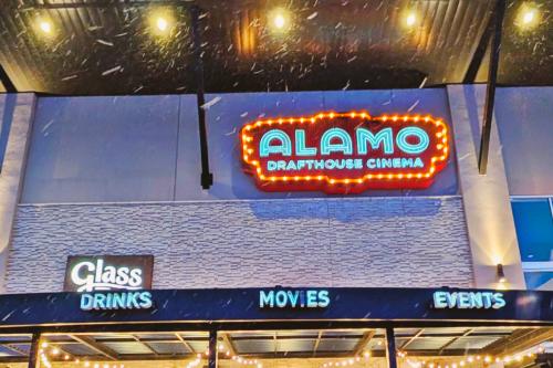 Exterior lights and sign of Alamo Drafthouse Cinema in Woodbury