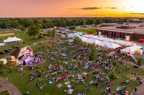Aerial photo at sunset with live band performing at bandshell in front of hundreds of people at Woodbury Days.