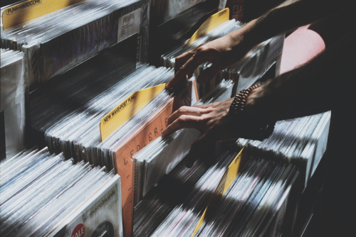 Man sorting through a collection of vinyl records