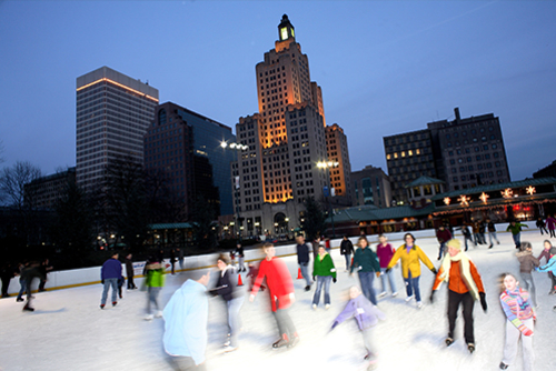 People Ice Skating outdoors in Providence RI at dusk