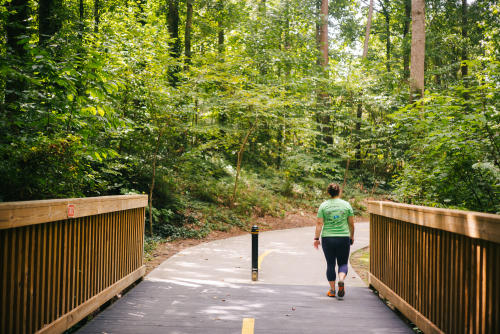 A person walking on the trails at Brook Run Park