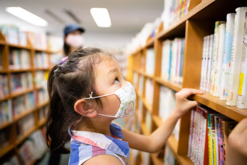 Child in Library with Mask