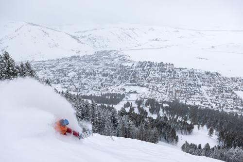 Snow King Snowboarder Overlooking Town