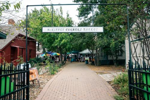 Wrought iron gates opening up to a beautiful courtyard at Chestnut Square Heritage Village where the McKinney Farmers Market is held