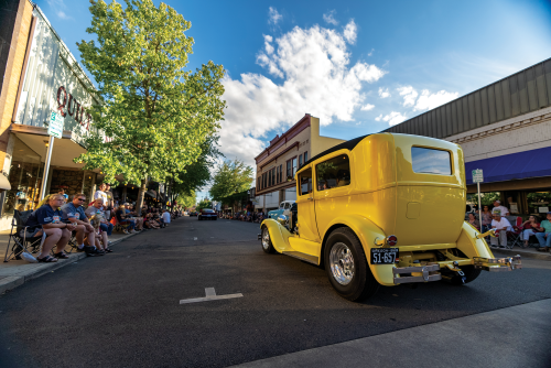 Classic car rolls down Jackson Street in downtown Roseburg during Graffiti event.