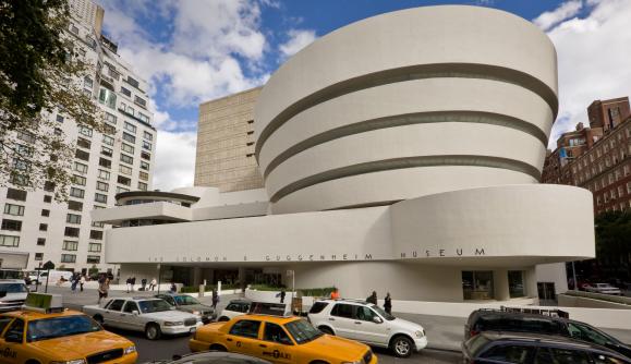 Exterior of the Solomon R. Guggenheim Museum, New York with cars and cabs in street Exterior of the Solomon R. Guggenheim Museum, New York with cars and cabs in street