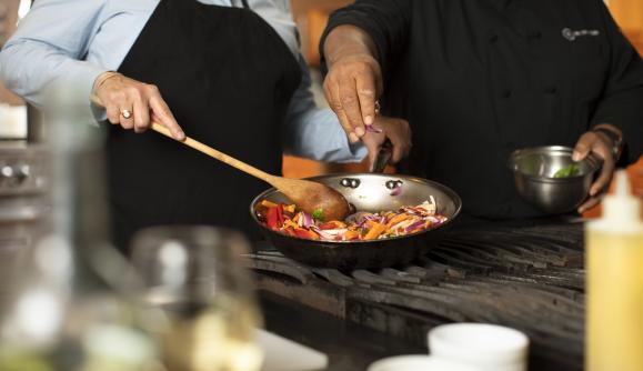 Two people cooking at New York Kitchen; Photo Credit: Grant Taylor Photography Two people cooking at New York Kitchen; Photo Credit: Grant Taylor Photography