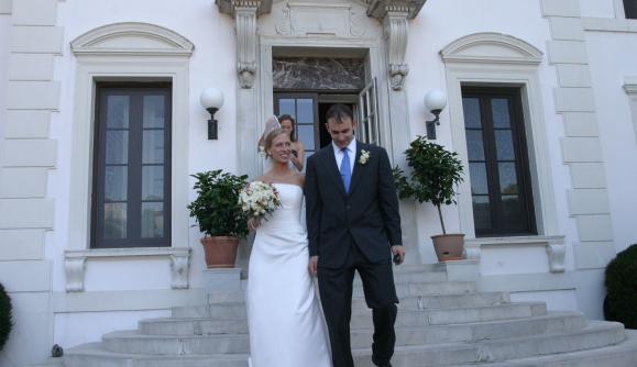A bride and groom walk down the steps at Geneva on the Lake A bride and groom walk down the steps at Geneva on the Lake