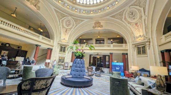 The Battle House Hotel lobby is a large, circular room with a high dome ceiling that has stained glass windows
