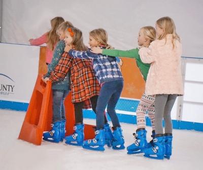Kids skating in a line at Evans on Ice