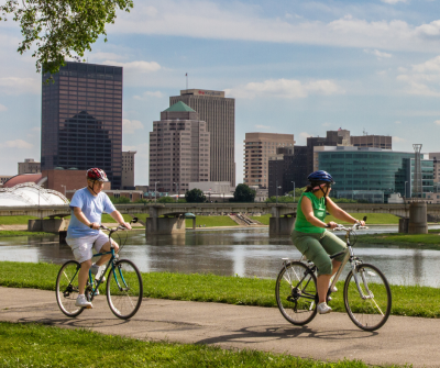 Bill Franz photo - two people biking with city skyline background