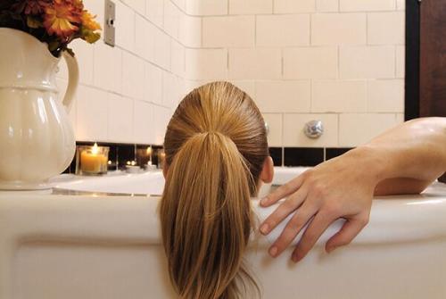 Woman relaxing in a bathtub