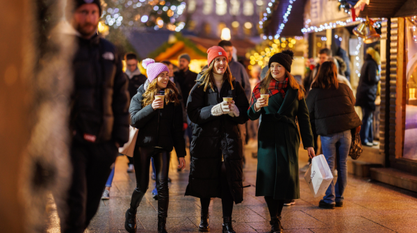 Girls drinking hot chocolate at Belfast Christmas Markets.