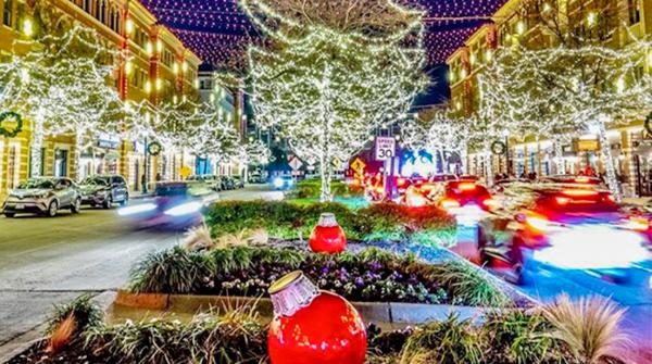 Christmas lights on trees and between buildings in Frisco square