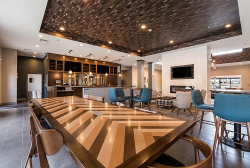 A long wooden table sits in the middle of the common dining area at the Four Points in Elkhart, Indiana