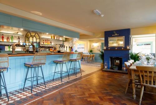A view inside The Wittering pub, with bar and fireplace
