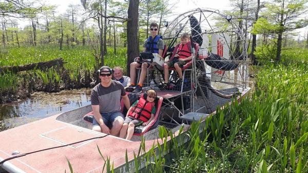 People on an airboat in a swamp in Beaumont, TX