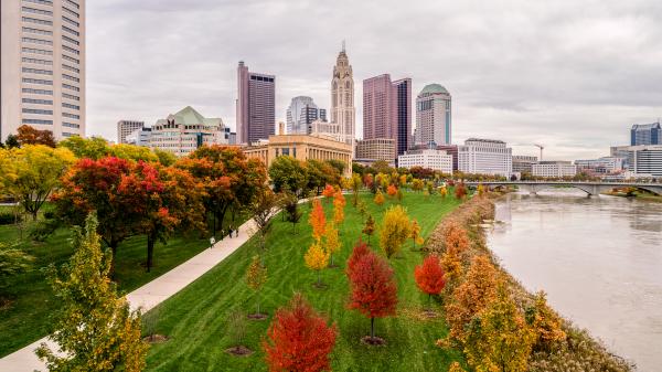 Columbus skyline view from the Scioto River. Fall foliage surrounds the area