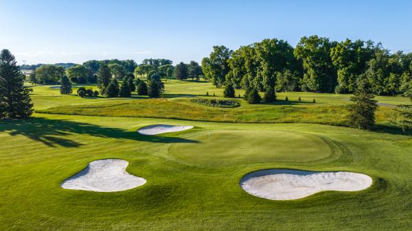 A golf green surrounded by three sand traps at The Club at Twin Lakes in Allentown, Pa.