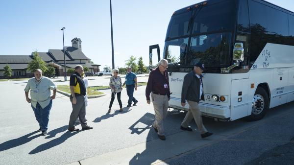 Group of travelers exiting motorcoach bus at Cumberland County stop