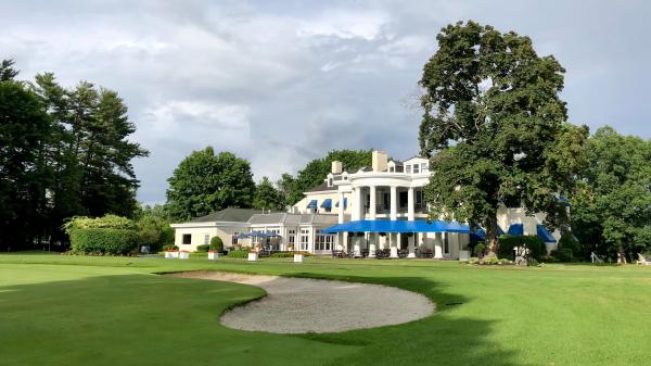 lush green grass with clubhouse in the backround