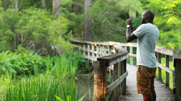 Man Birding at Northlake Nature Center in Mandeville, at the edge of Big Branch NWR