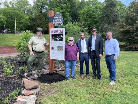 group of people by a historic marker