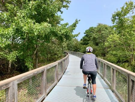 A biker rides down the Gordons Pond Bike Trail in Lewes, Del.