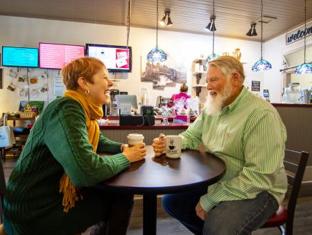 Couple laughs over coffee at Coffee on Raiford in Selma, NC
