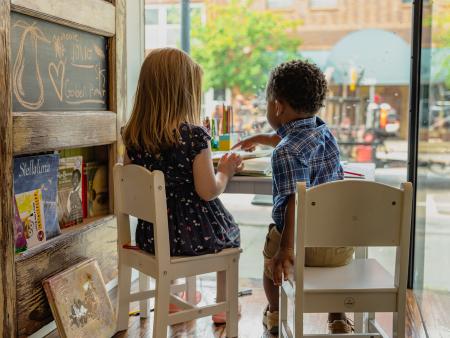 Kids playing together in window of Gilded Pear Coffee Shop