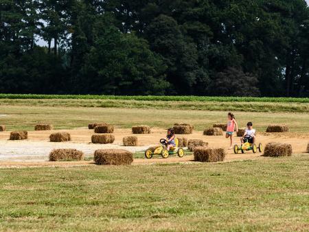 Young kids riding pedal carts at Sonlight Farms in Kenly, NC.
