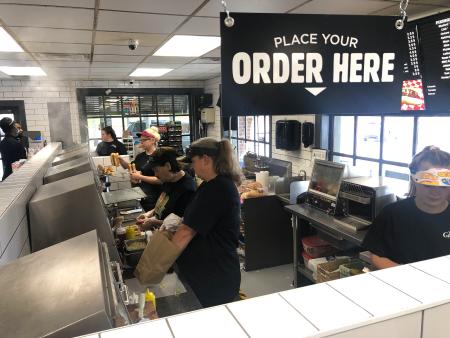 Workers at the Grocery Bag Serving Up Hot Dogs