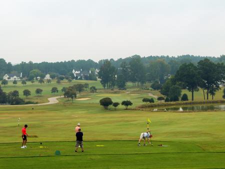 Riverwood Golf Course group of men on the green in Clayton, NC.