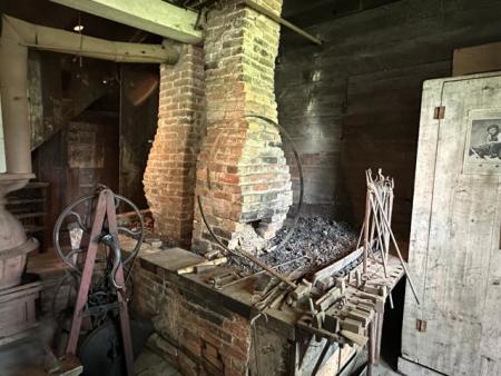 This fireplace served as a soldering area to shape wheels and other parts.
